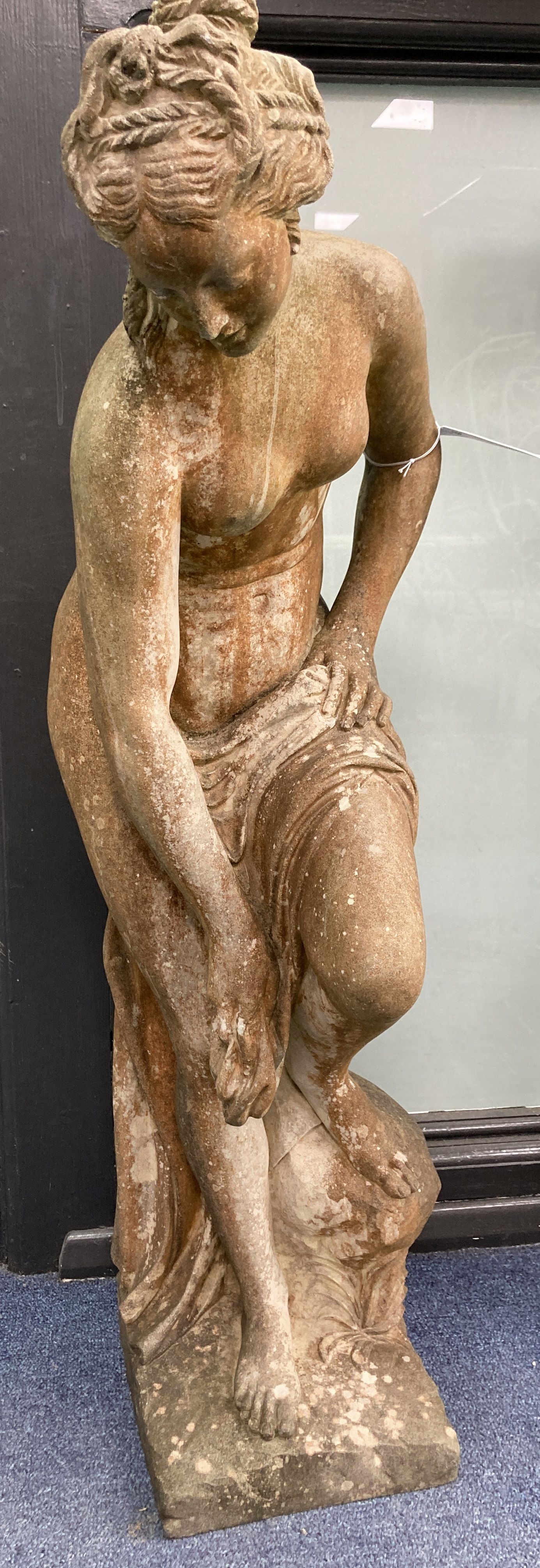 A reconstituted stone garden ornament of a female bather, height 74cm